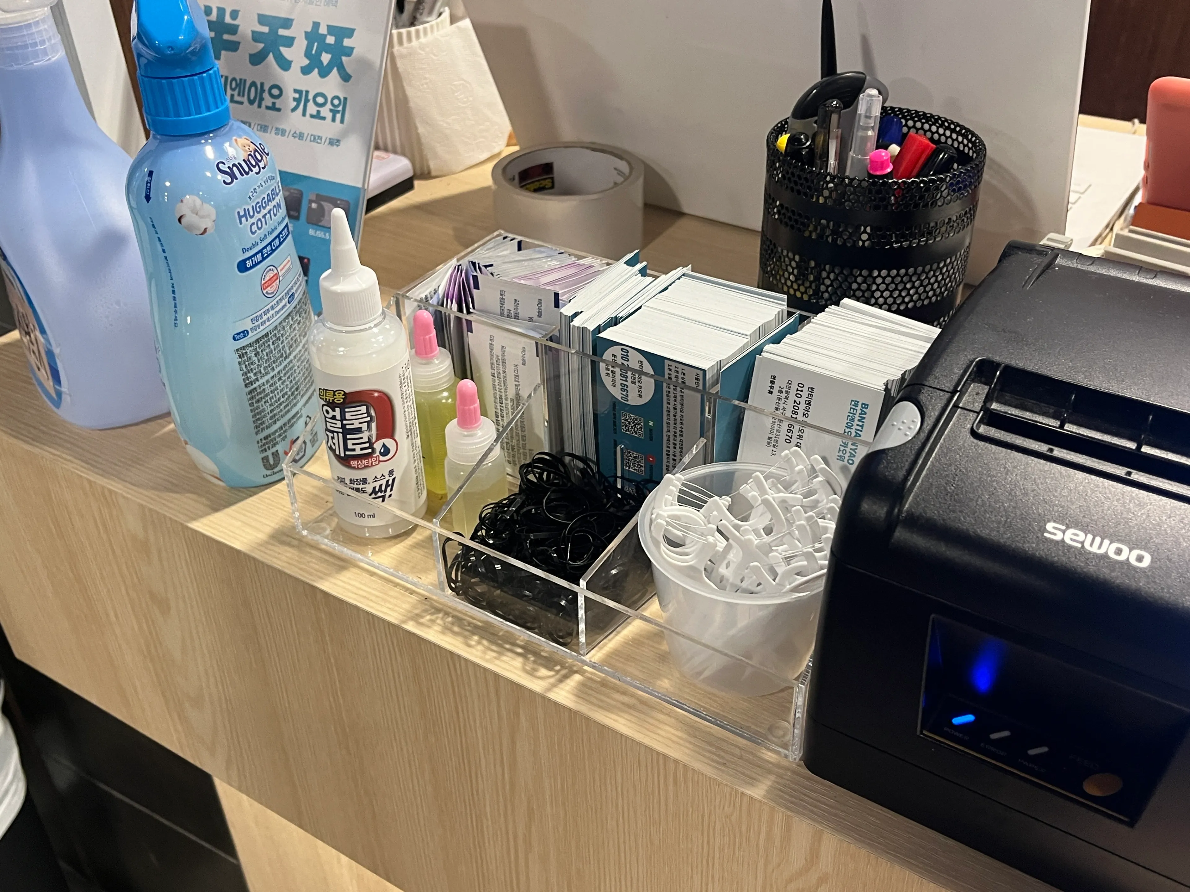 Floss, stain remover, and fabric deodorizer set at the checkout counter
