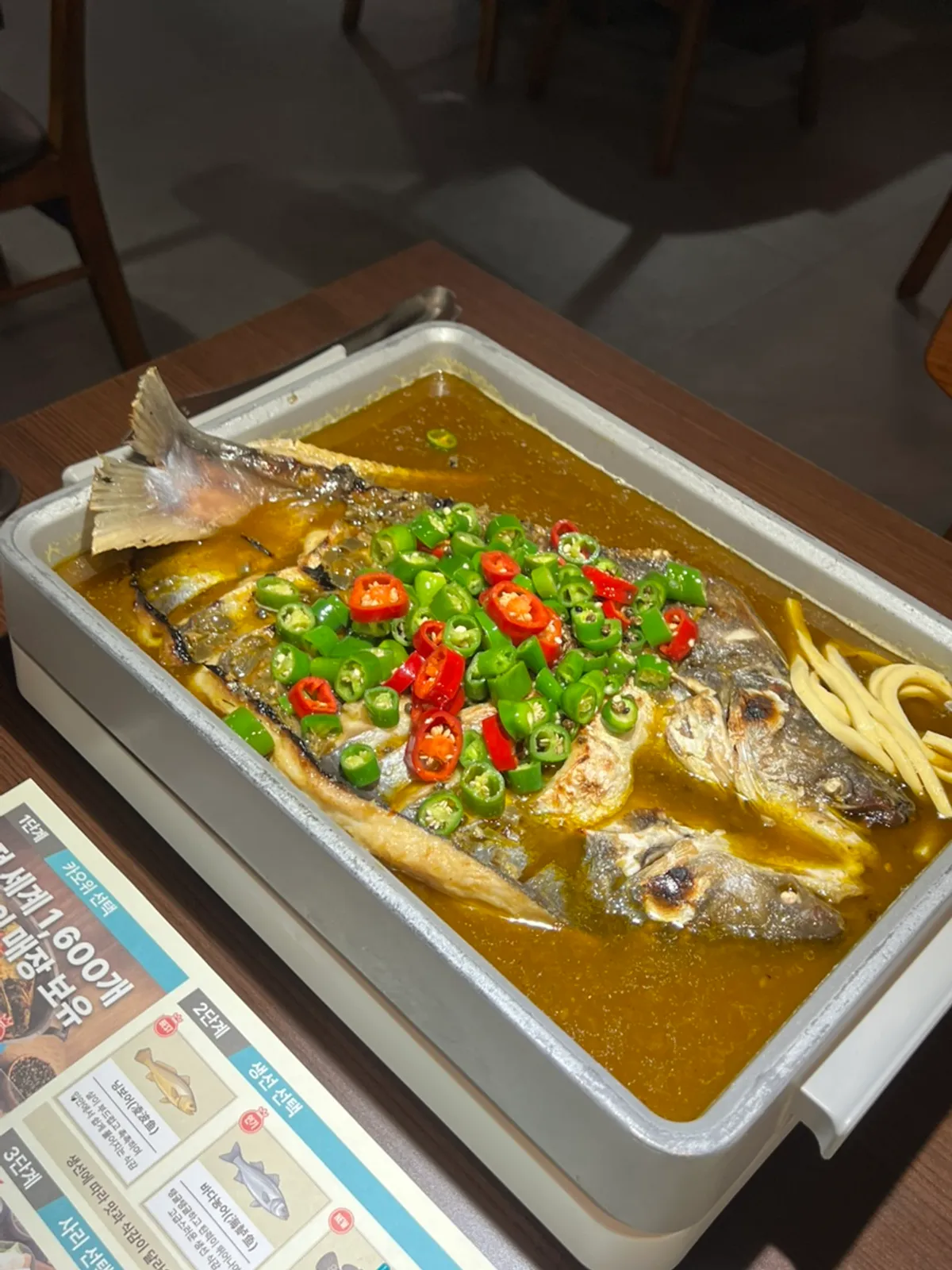 Qinghuajiao kaoyu served in a large pan