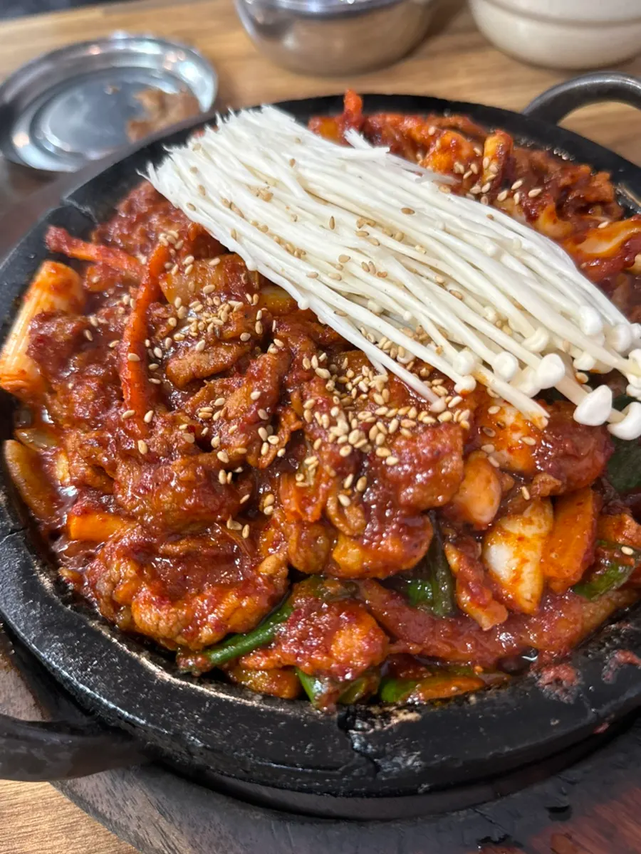 Fire-grilled squid-and-pork stir-fry served on a hot stone plate