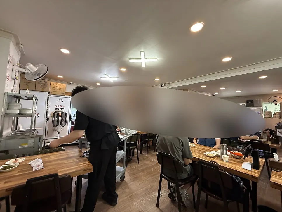 Corner of the restaurant with origin sign and baby chair