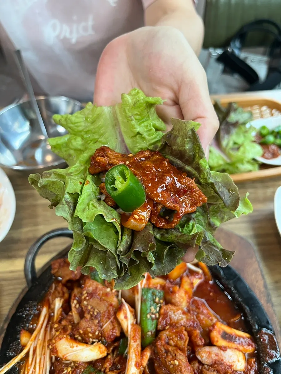 A wrap of fire-grilled pork with ssam vegetables