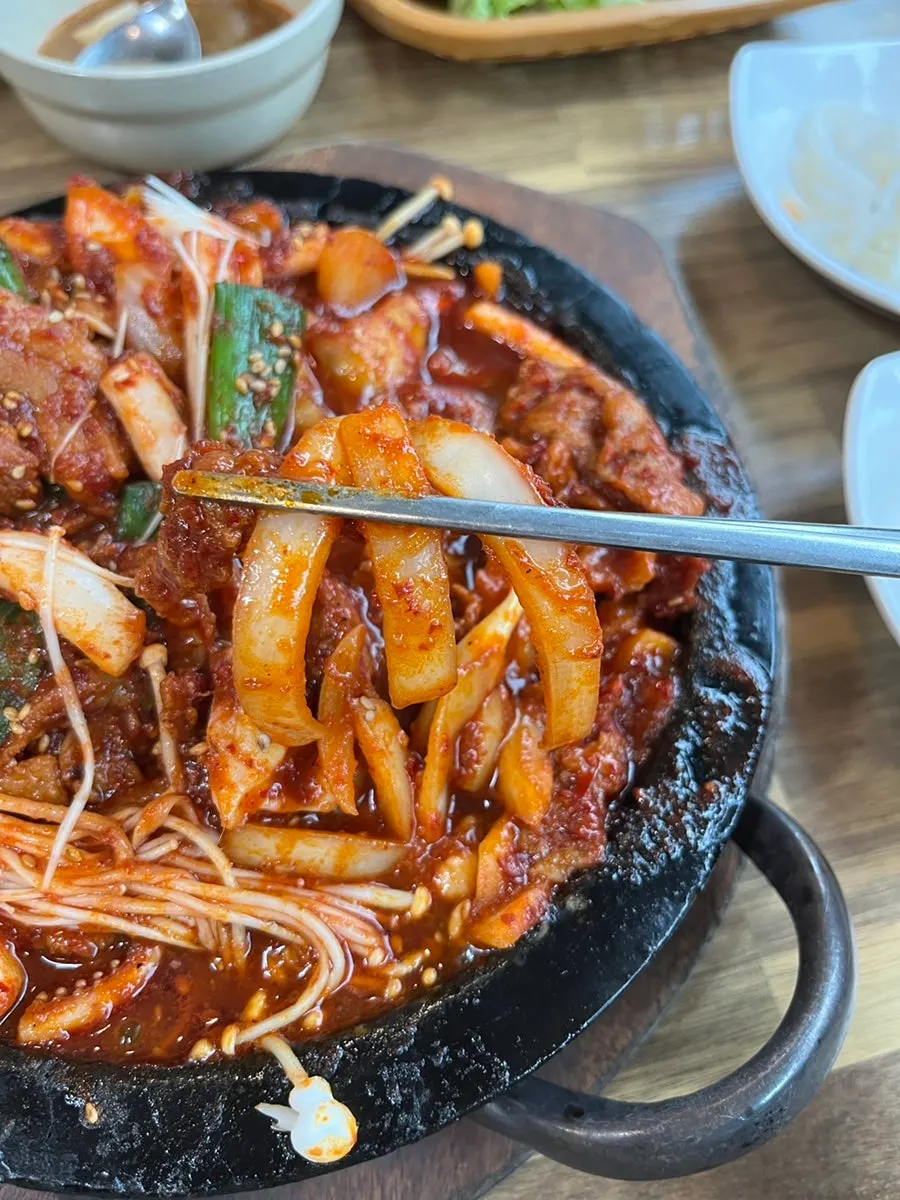 Onions in the squid-pork combo with a bowl of rice