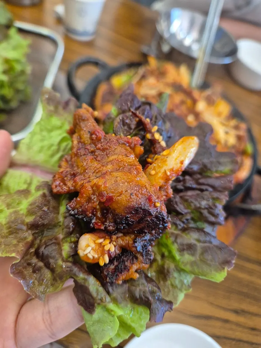Close-up of fire-grilled pork stir-fry with charcoal aroma