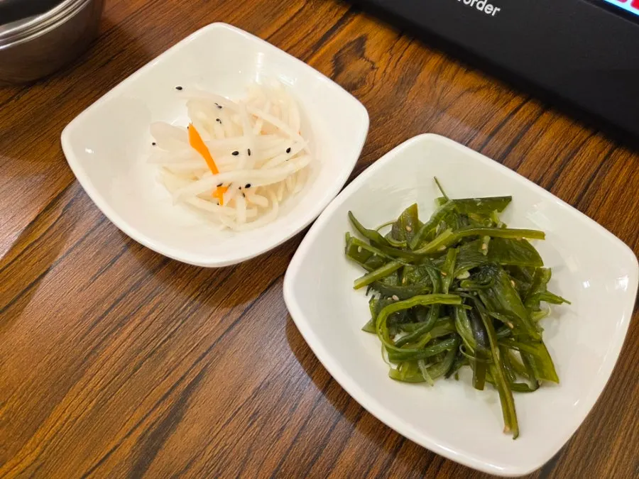 Basic side dish spread with seaweed stem, radish salad, and bean sprouts