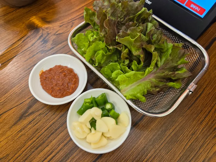 Ssam vegetables and garlic brought over from the self-serve bar