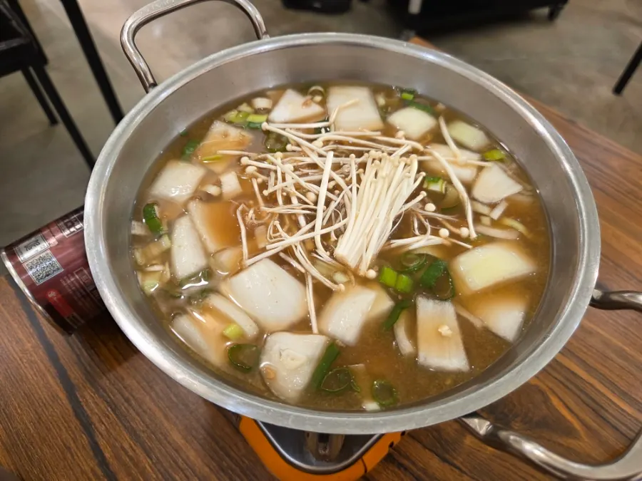 A table setting with the free cheonggukjang stew served