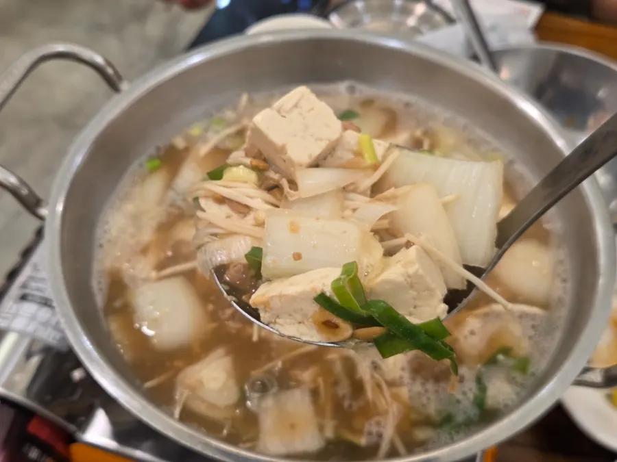 Cheonggukjang stew in a stone pot, packed with ingredients