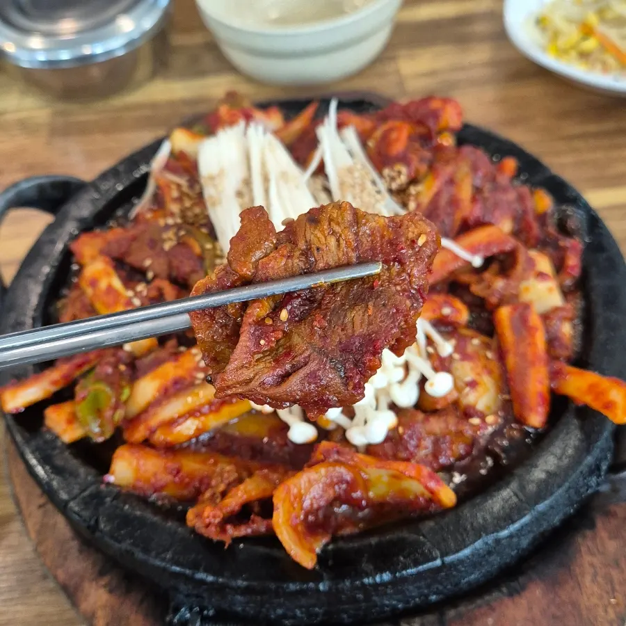A meal spread with cheonggukjang stew and black rice