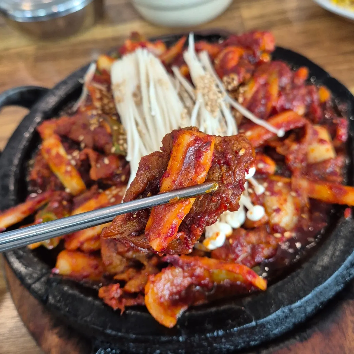 Full table spread of squid-pork stir-fry and cheonggukjang stew at Banwoldang Bujasikdang