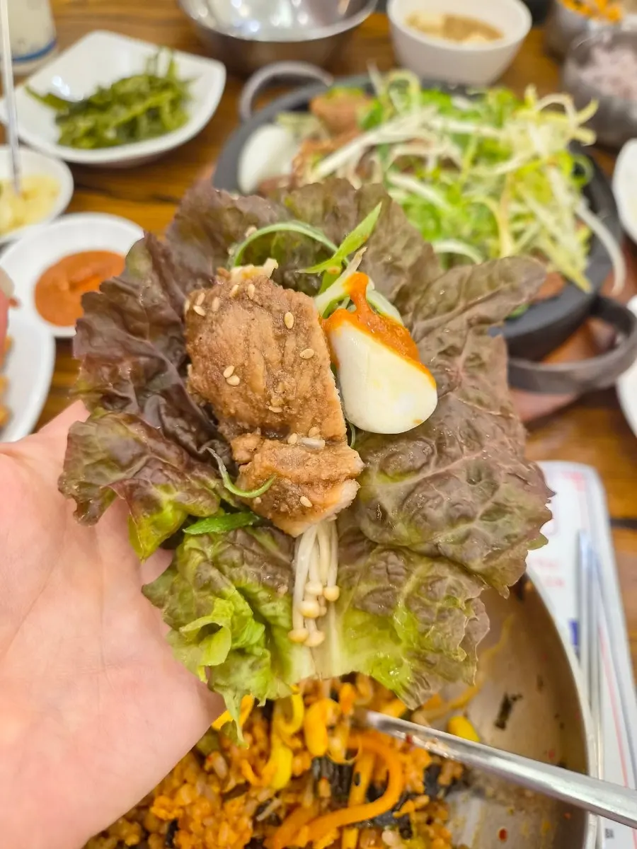 A ssam wrap with seokgalbi and shredded scallions