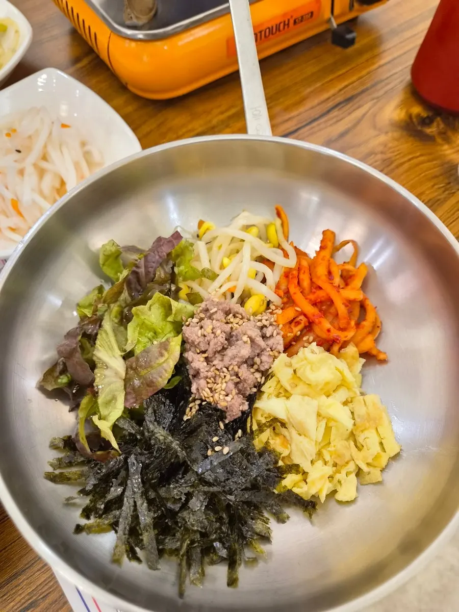 Close-up of seokgalbi cooking on the stone plate