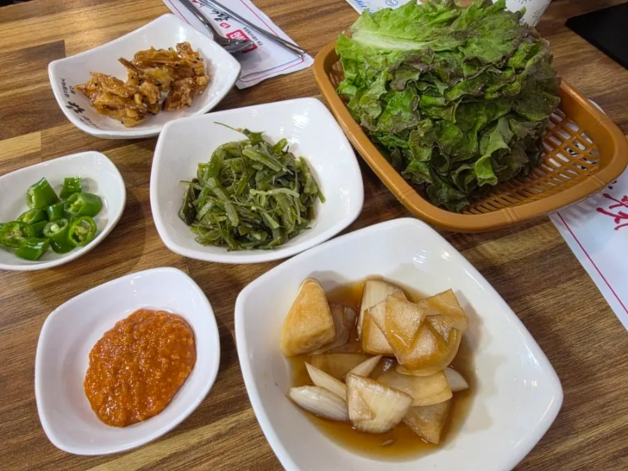Generous table setting with wrap vegetables and side dishes