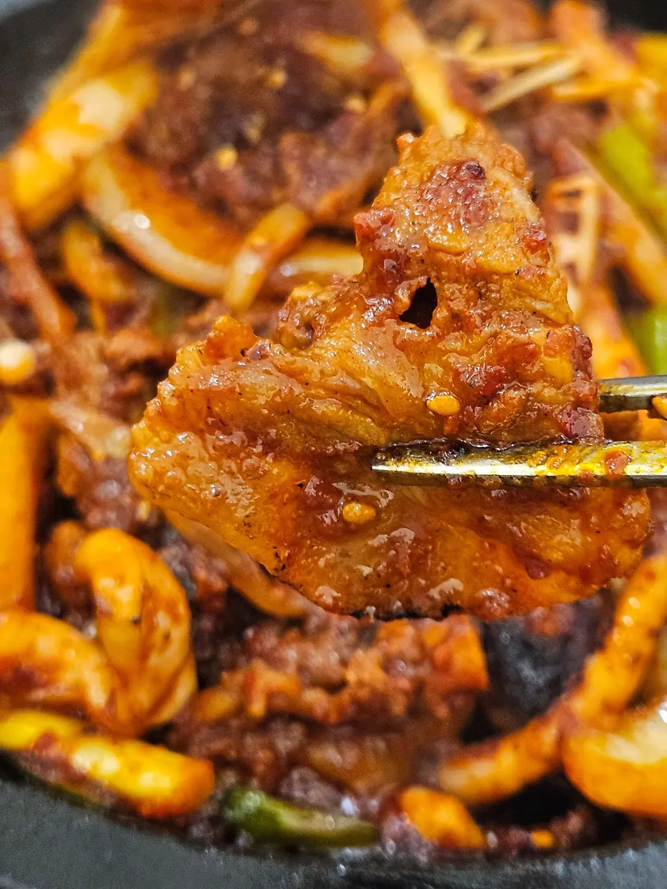 Close-up of sauce-coated pork and squid