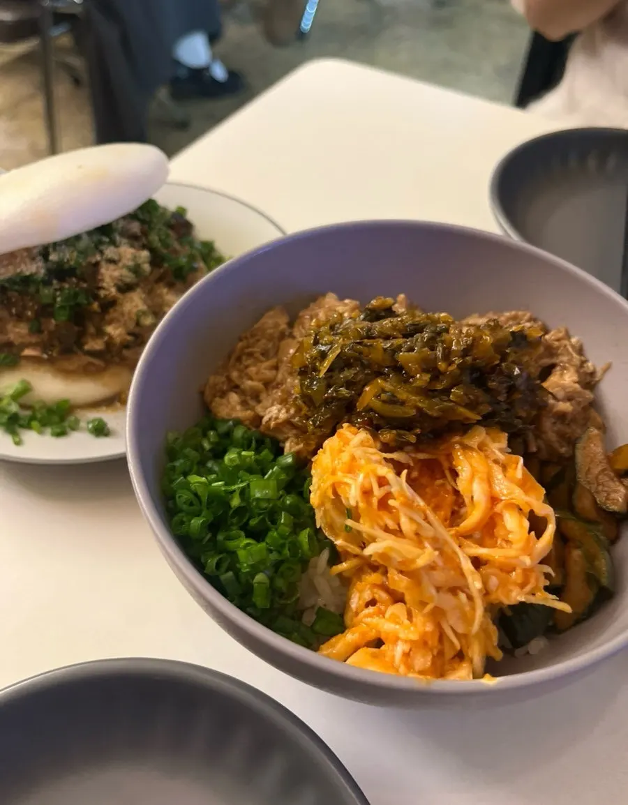 A table spread with the braised pork rice bowl