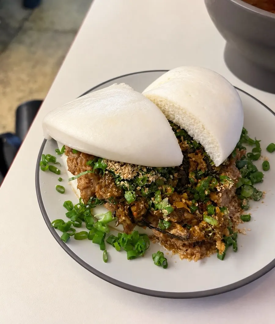 Soft bun filled with ingredients in the classic bao