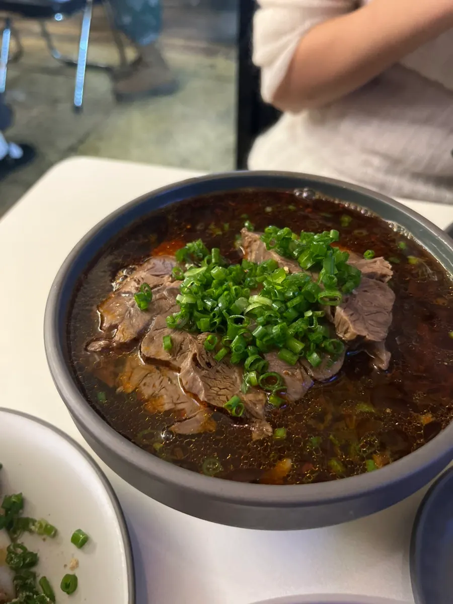 A bowl of Taiwanese beef noodle soup with rich broth