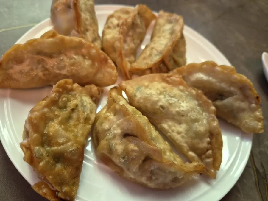 A plate of crispy handmade fried dumplings