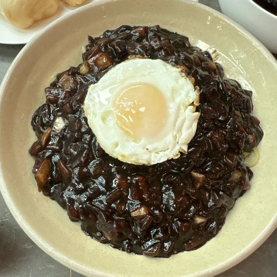 Table with sweet and sour pork and jjajangmyeon
