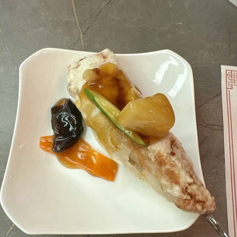 A piece of raw sirloin skewer sweet and sour pork dipped in sauce