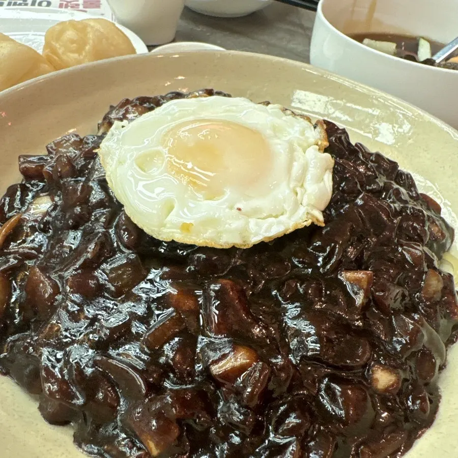 Large jjajangmyeon topped with a fried egg