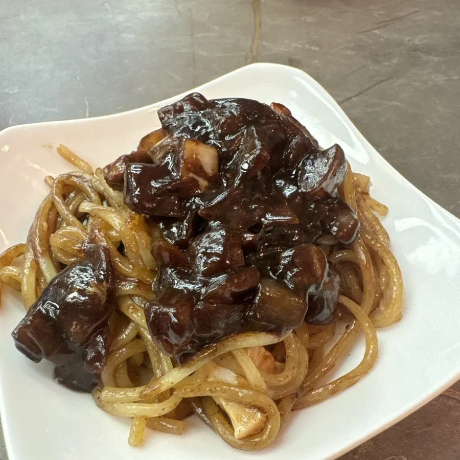 Jjajangmyeon mixed with a burst egg yolk