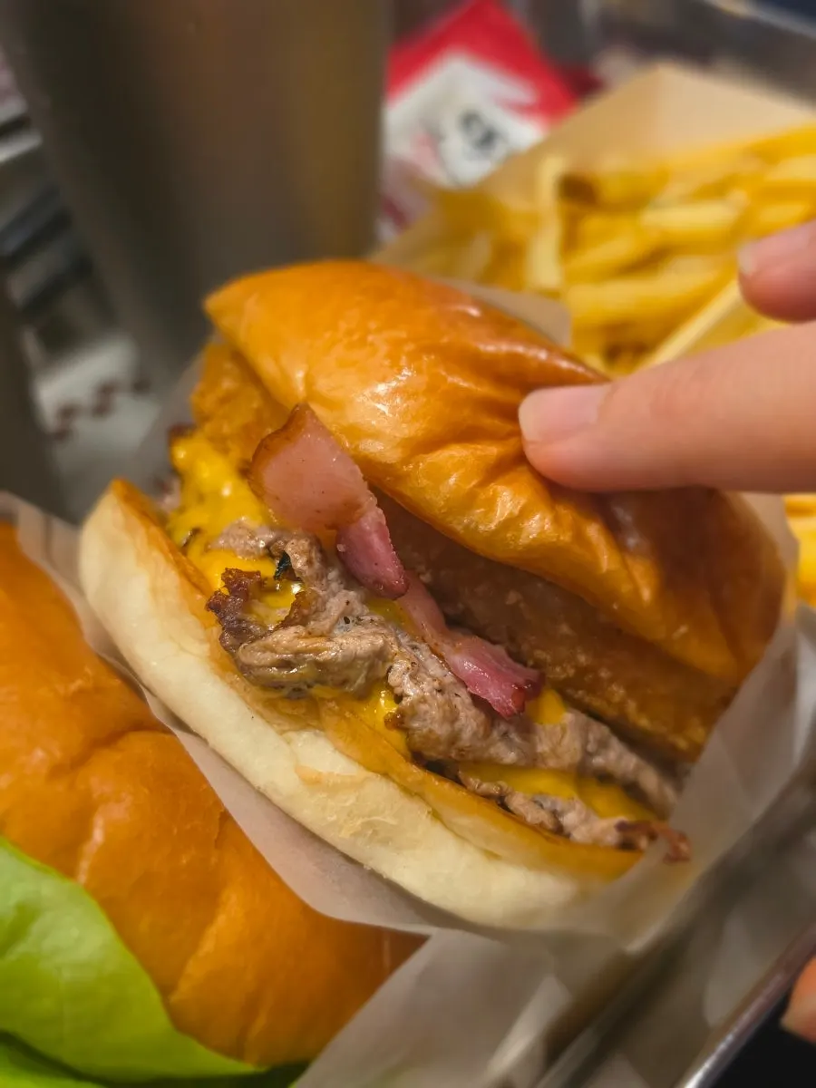 Bas Burger set, Double Bacon Cheese Burger set, and Double Crunch spread out on the table