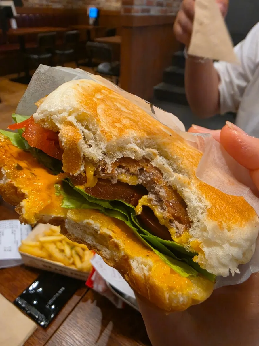 A bite taken out of the Double Bacon Cheese Burger
