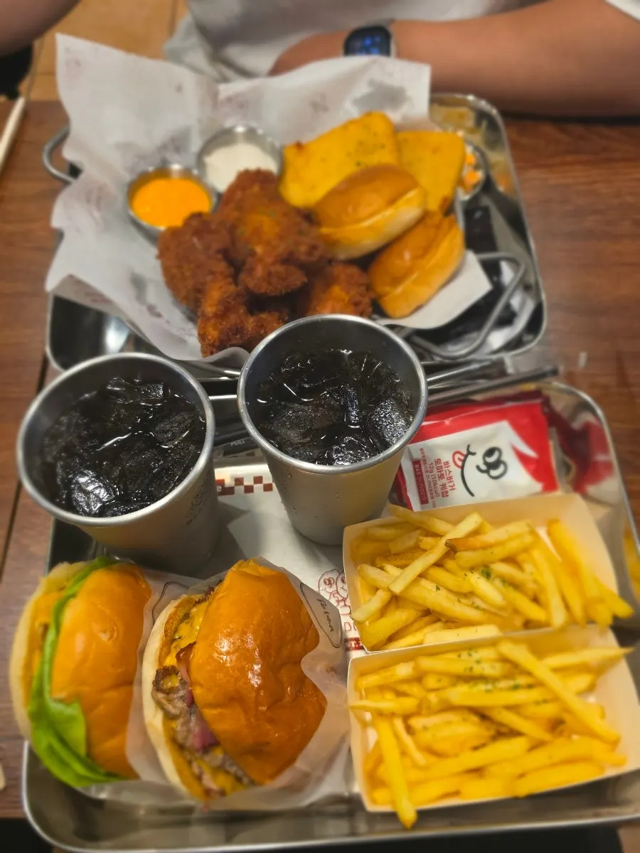 A table full of burgers and side dishes