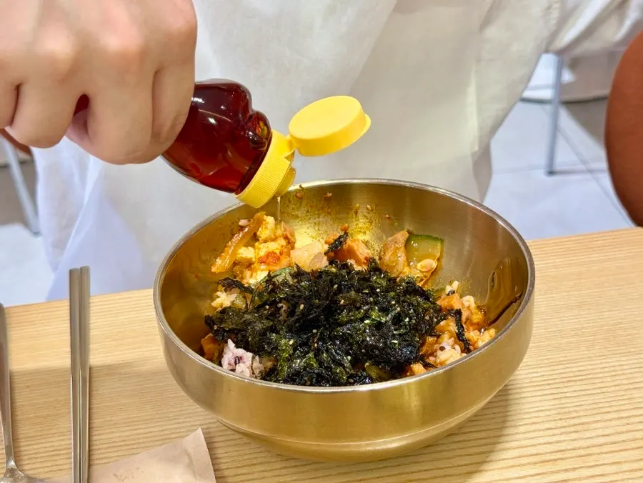 Stew broth and solids poured into a rice bowl