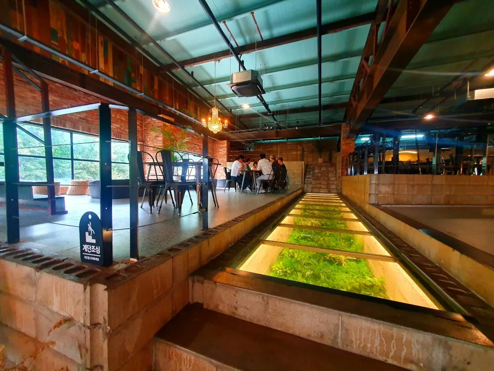Café interior photo zone styled with large plant installations