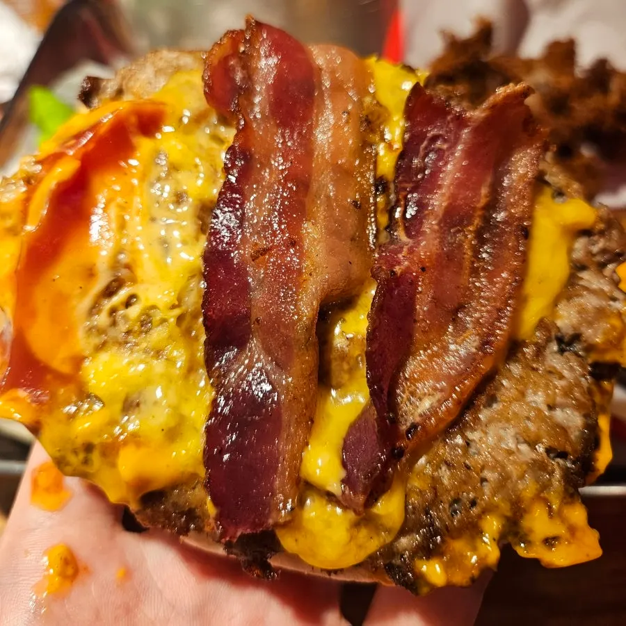 Double bacon cheese burger topped with a fried egg