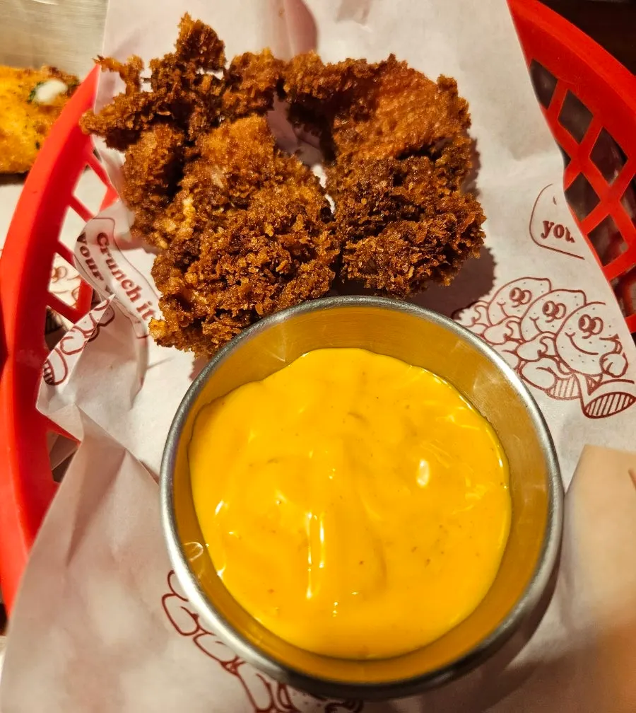Shrimp burger filling with shrimp and onion rings visible