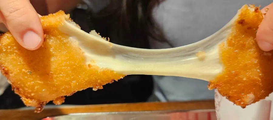 Long cheese pull from the mozza cheese bar