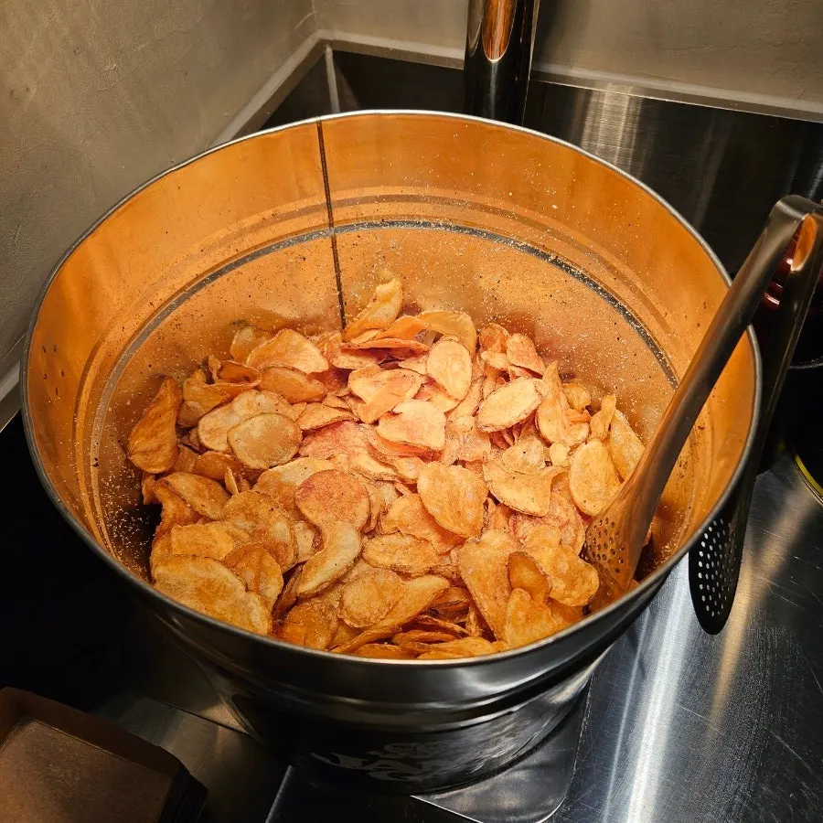 Crispy potato chips brought to the table on a plate
