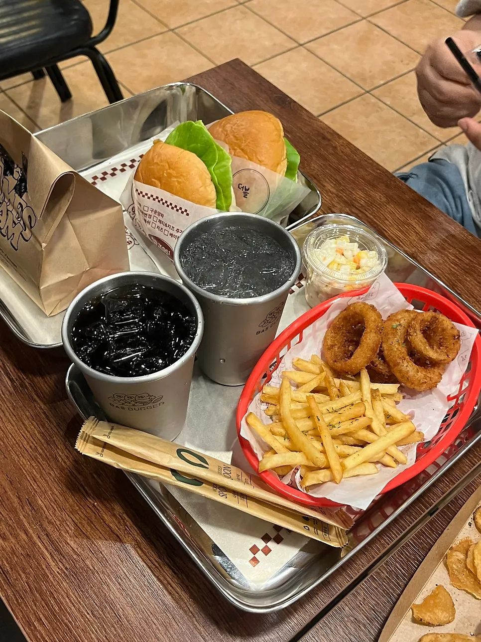 Double Bas Burger held in hand with a bite taken out