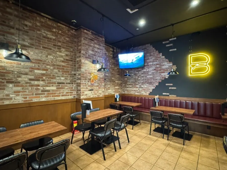 Wide hall view with tables for 2-4 people