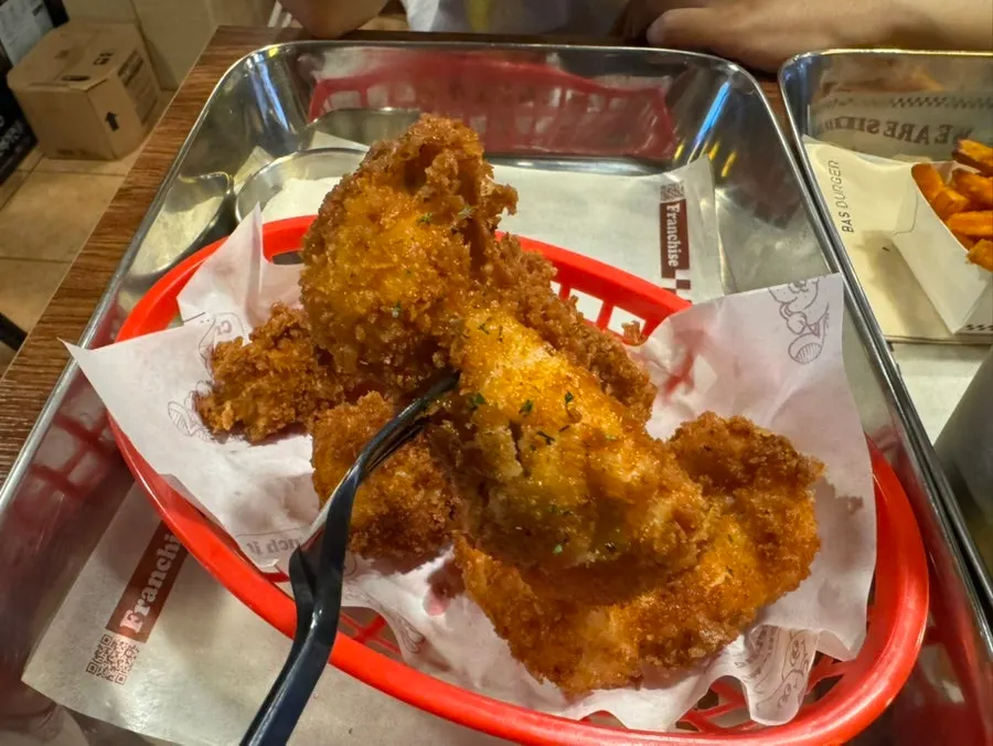 Boneless chicken served alongside the burgers