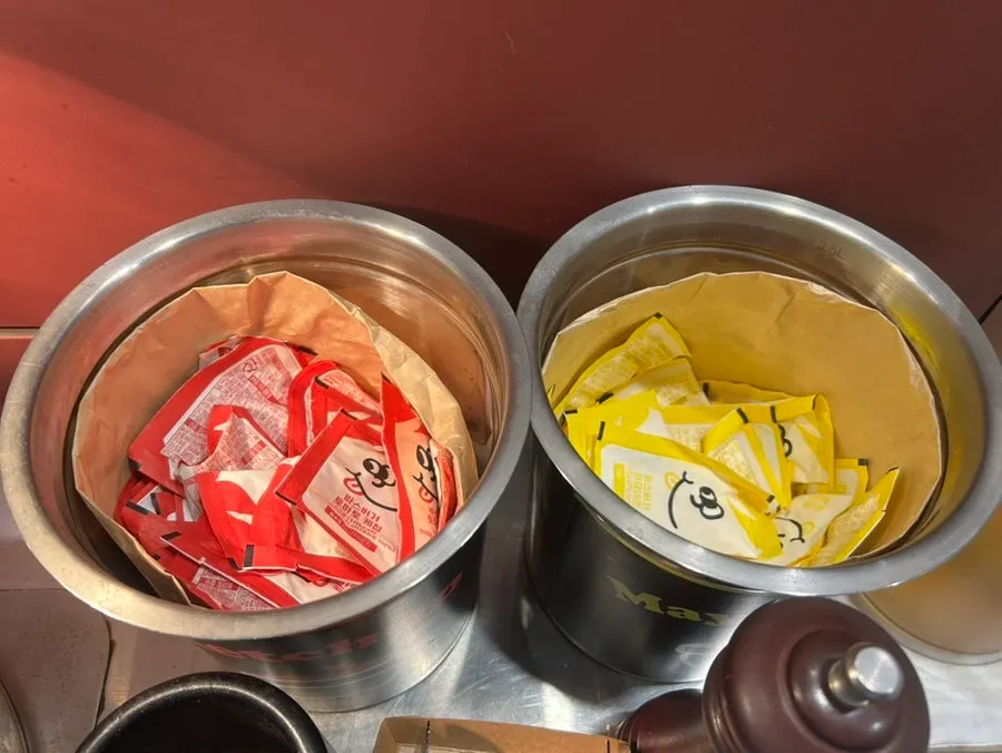 Self-bar with water, cups, ketchup, mayonnaise, and pepper