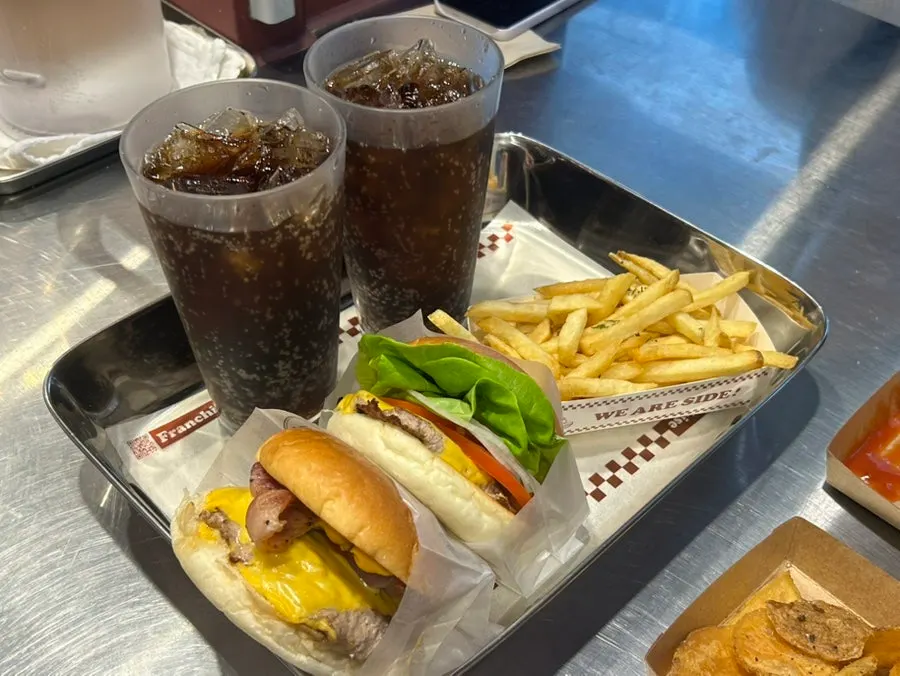 Table with the burger sets and singles ordered by four people