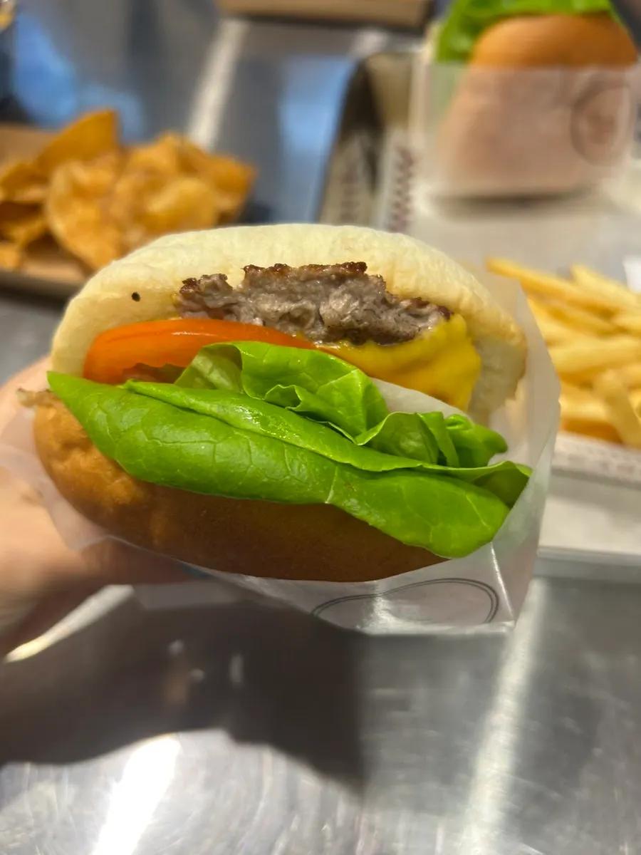 Cross-section of the Bas Burger with beef patty, vegetables, and cheese