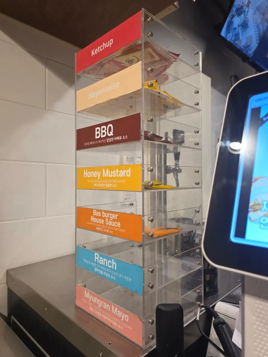 Self-service sauce corner with ketchup and BBQ sauce