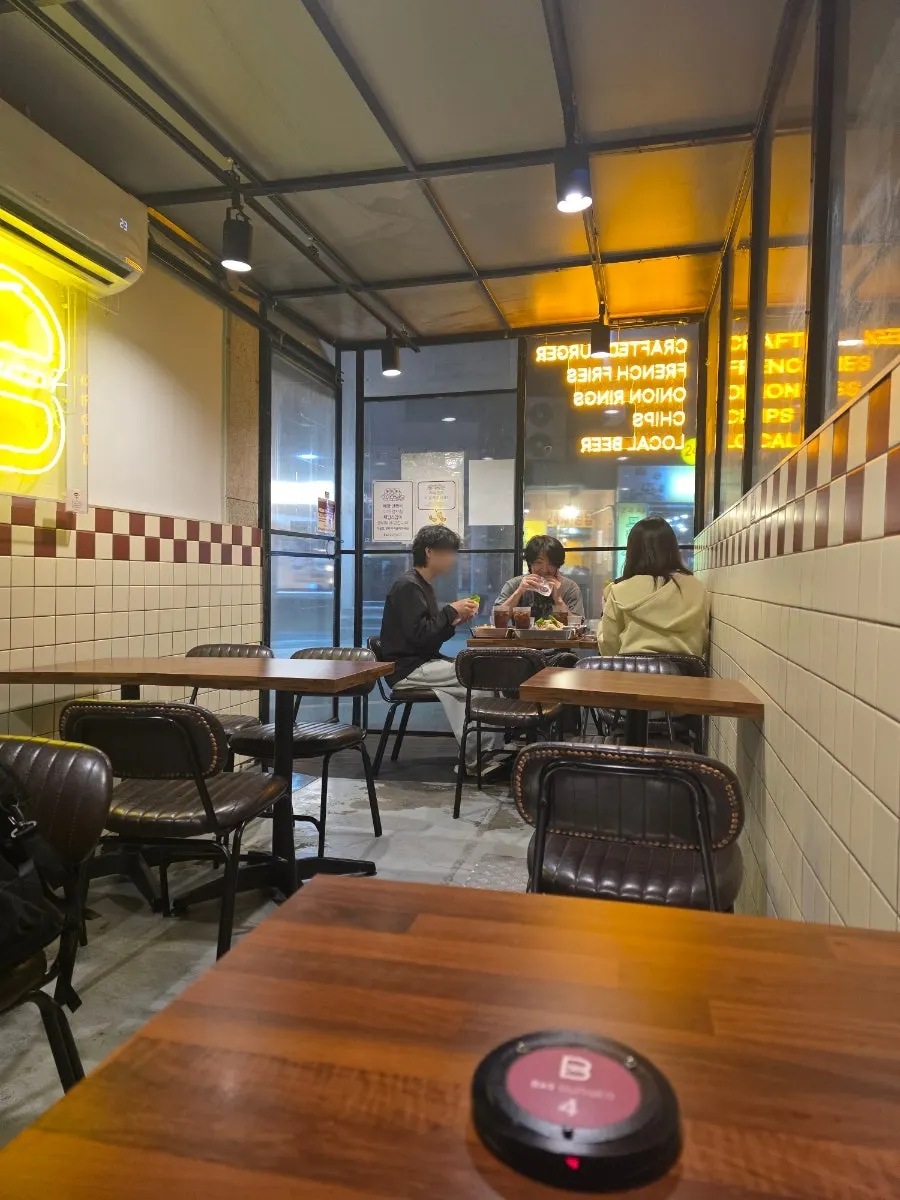 American-style burger shop seating with tile walls and wood tables