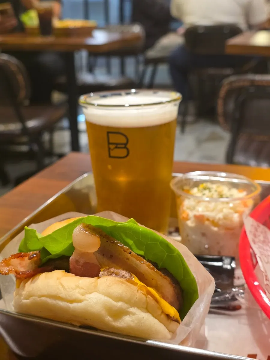 Hawaiian burger, coleslaw, mozza chicken bites, and draft beer spread