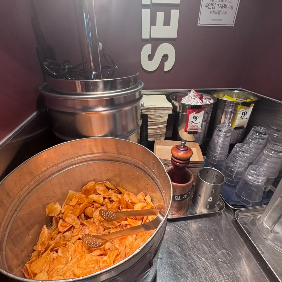 Self-serve station with sauces, napkins, and wet wipes