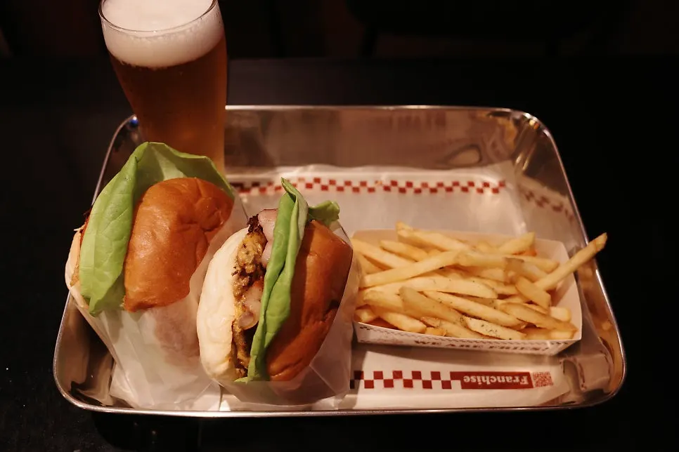 Handmade burger and Bas Lager beer laid out on the table