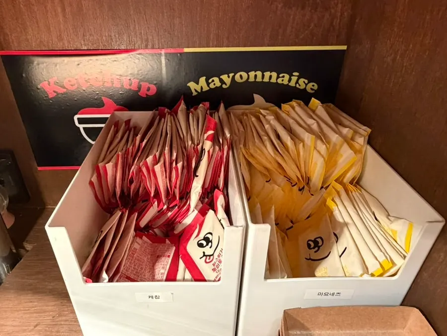 Self-serve sauce corner with mayonnaise and ketchup