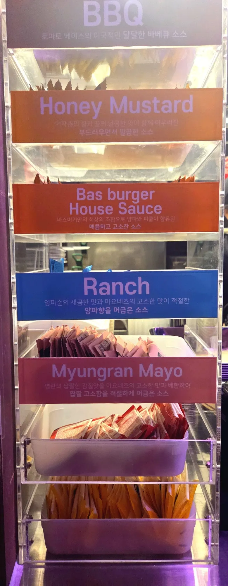 Signage explaining BAS Burger's 5 signature sauces