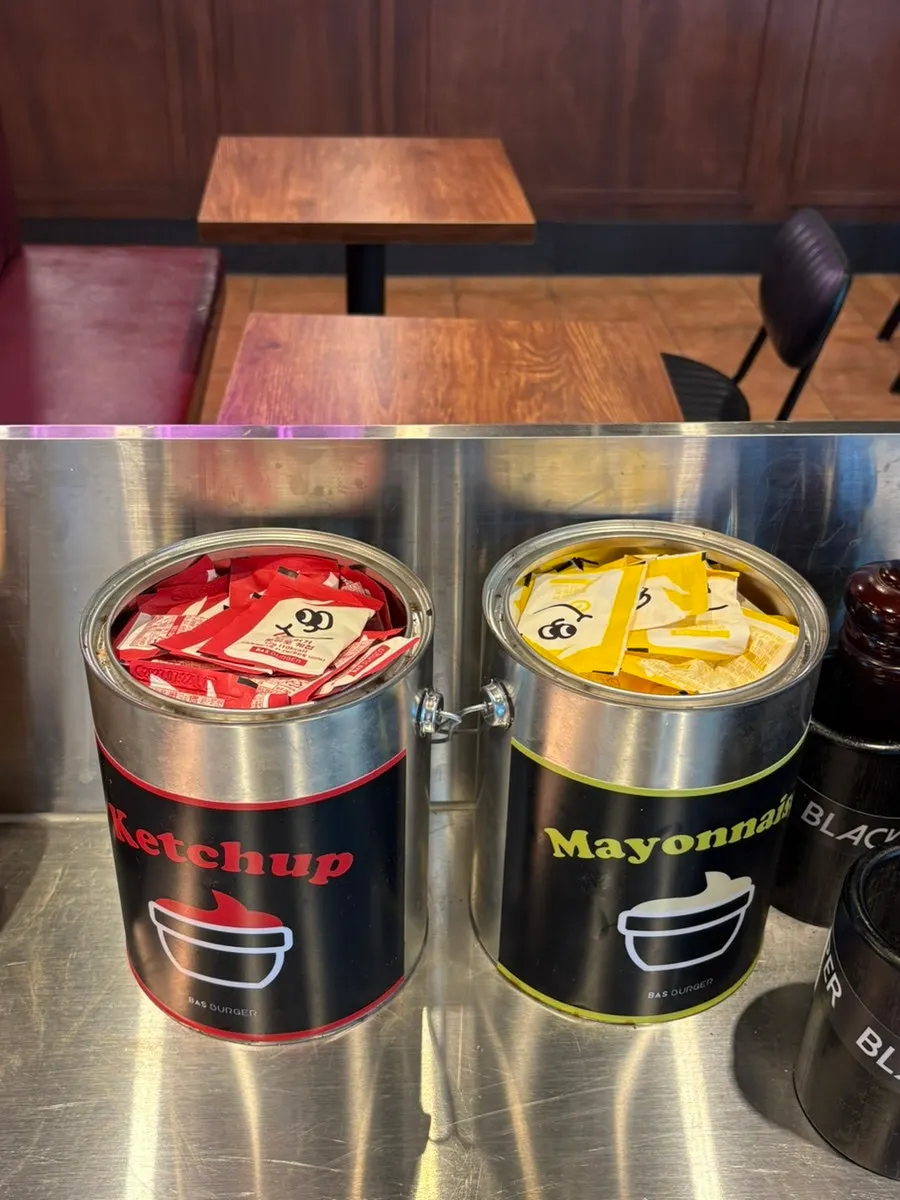 Sign for Bas Burger's signature menu items
