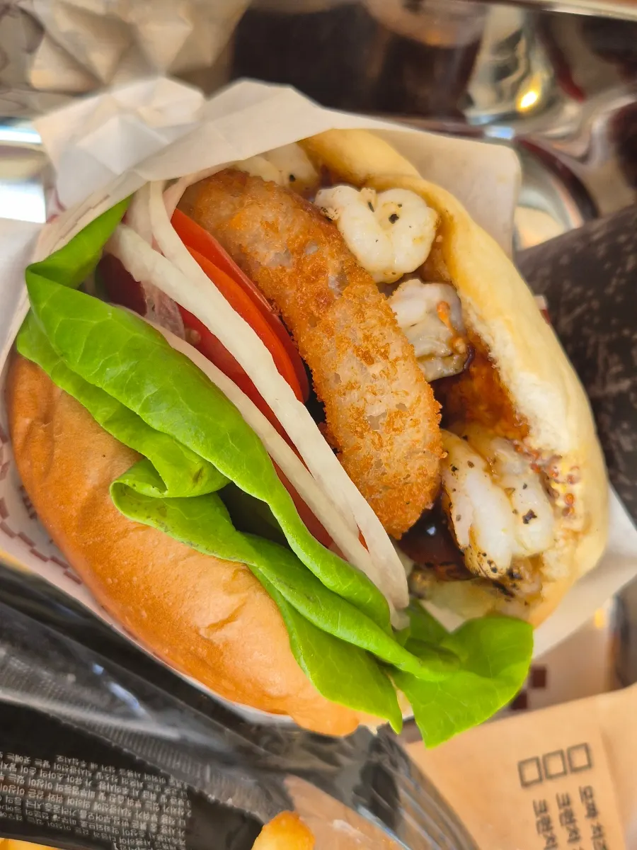 Cross-section of the wasabi mayo shrimp burger wrapped in a moist bun