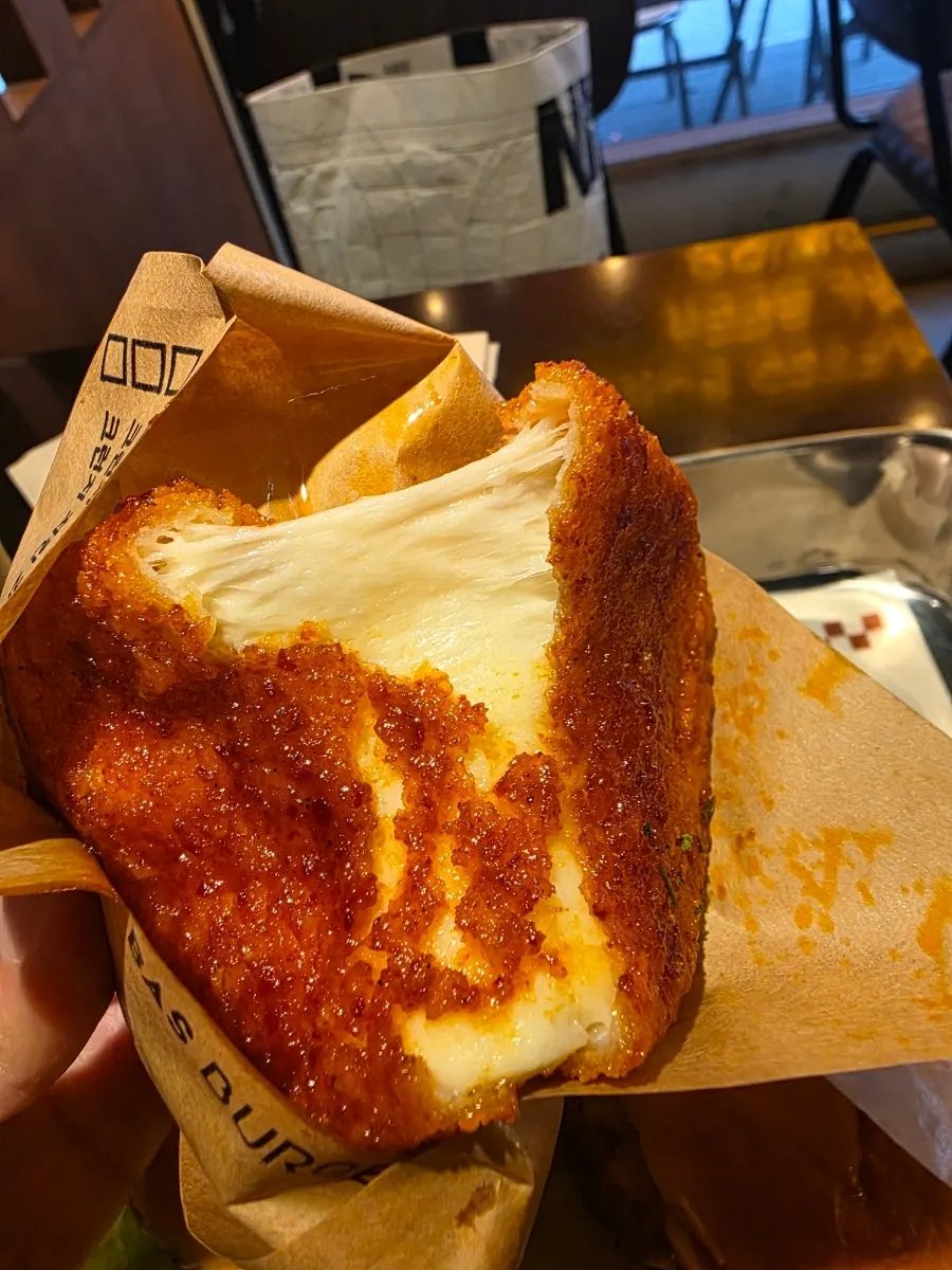 Cheese pull on the chili cheese bar